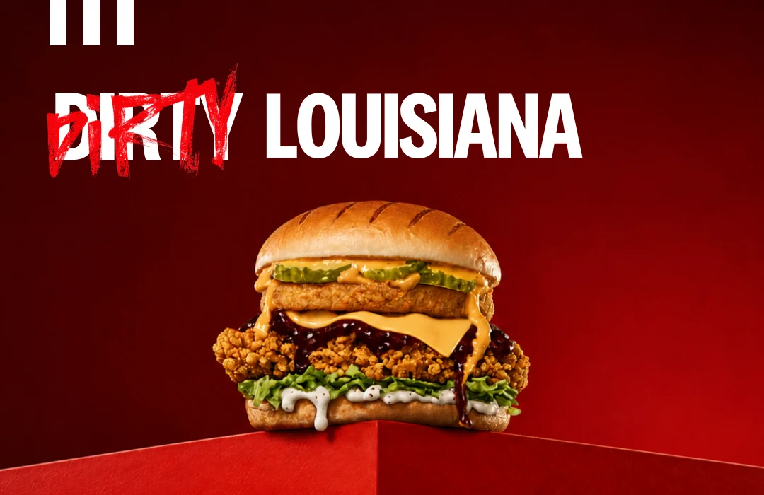 loaded chicken burger with cheese and sauce on a bun, against a red gradient background with 'dirty louisiana' text above.
